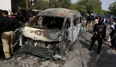 Pakistani investigators examine the site of the explosion in Karachi